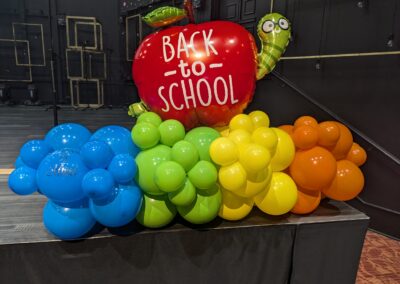 A vibrant balloon display celebrating the back-to-school season, featuring colorful balloons in various shapes and sizes.