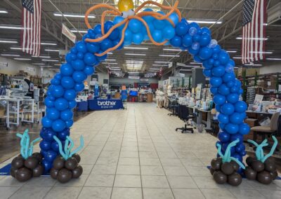 A vibrant balloon arch featuring an octopus and various colorful sea creatures, creating a festive underwater theme.